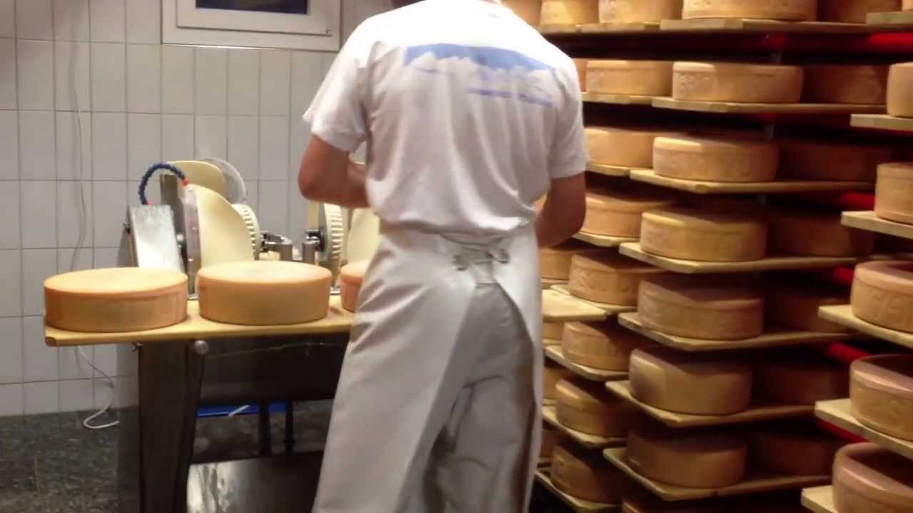 Cheese maker cleaning cheeses in his workshop | Stock Images Page ...