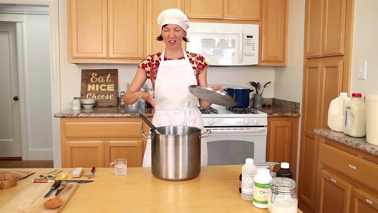 Cheese maker cleaning cheeses in his workshop - Stock Image - Everypixel